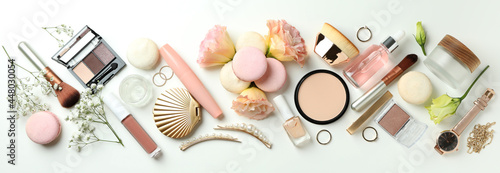 Female accessories and macaroons on white background