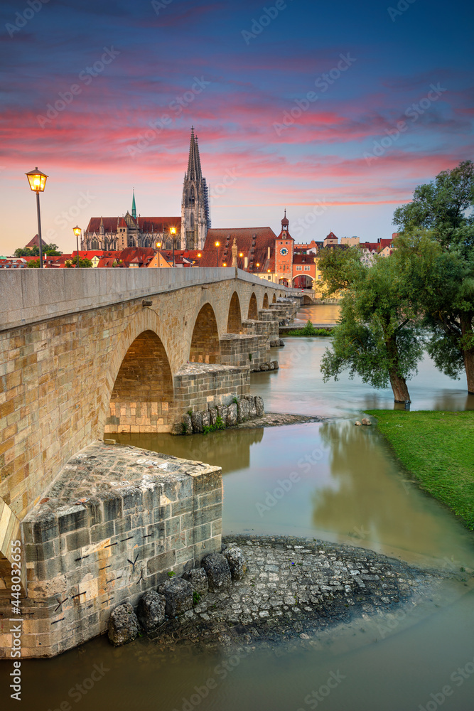Regensburg, Germany. Cityscape image of Regensburg, Germany with Old Stone Bridge over Danube River and St. Peter Cathedral at summer sunrise.