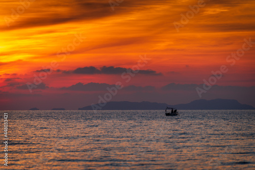 Fishing boat in the sea during sunset. Corfu island in Greece