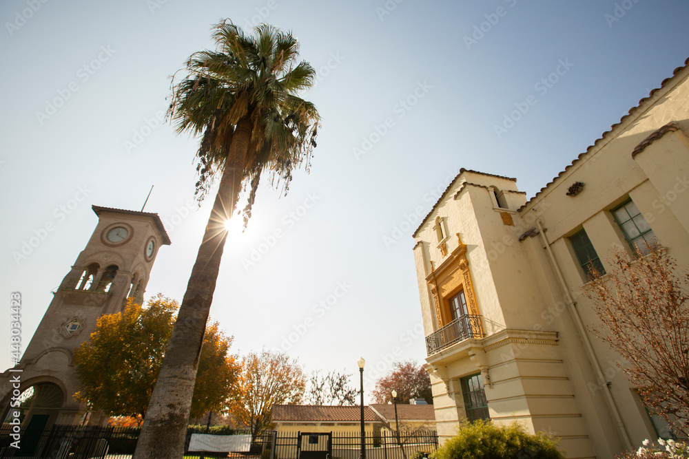 Fototapeta premium Daytime view of a historic public clock tower in downtown Bakersfield, California, USA.