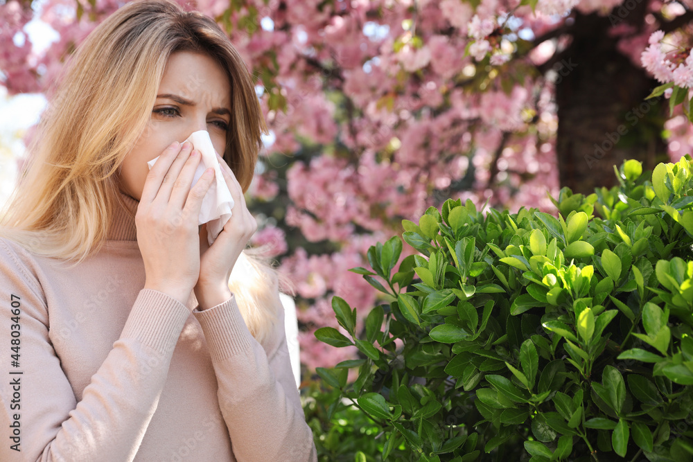 Woman suffering from seasonal pollen allergy outdoors Woman suffering from seasonal pollen allergy outdoors