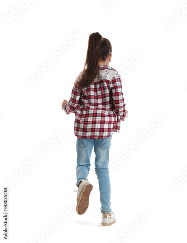 Cute little girl running on white background, back view photo