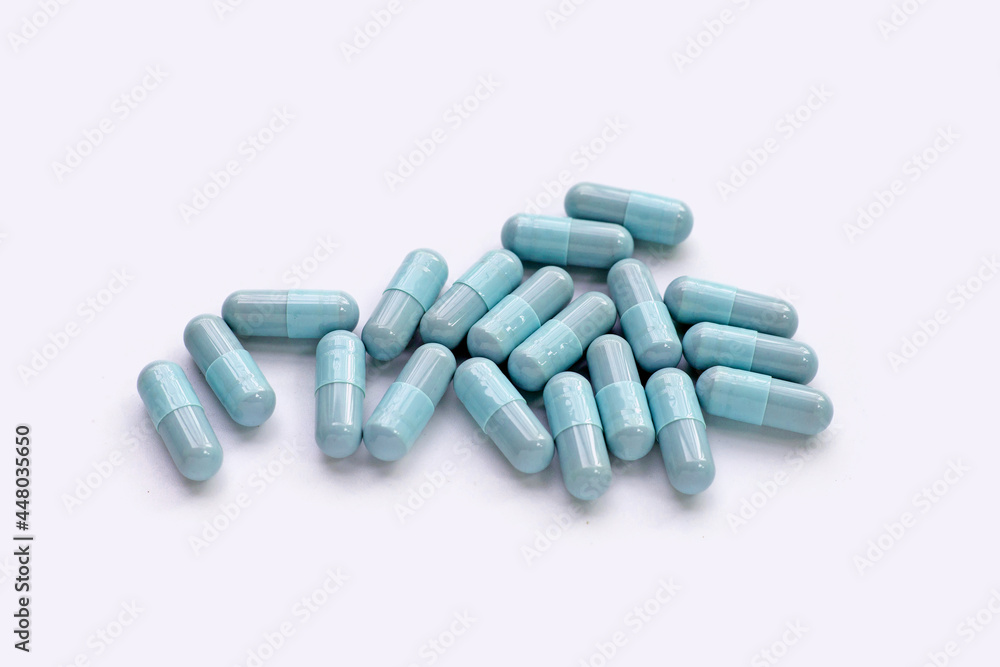 Blue capsules on white background