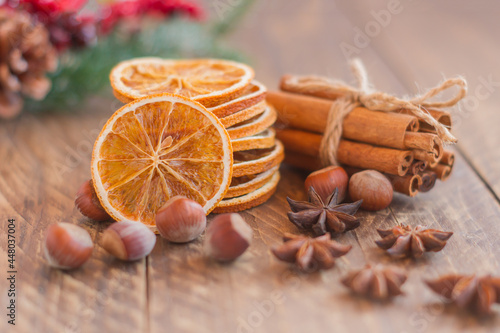 Christmas composition, arrangement of dry Oranges cinnamon sticks and star anise on wooden background. Rustic, Mediterranean, Holiday spices ingredients.