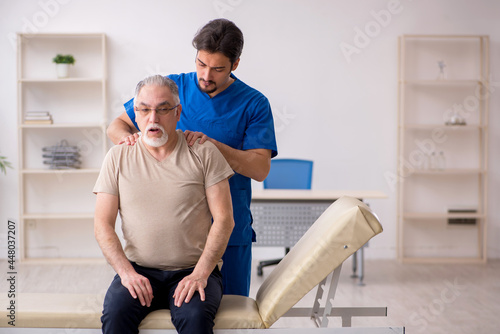 Old male patient visting young male doctor chiropractor © Elnur