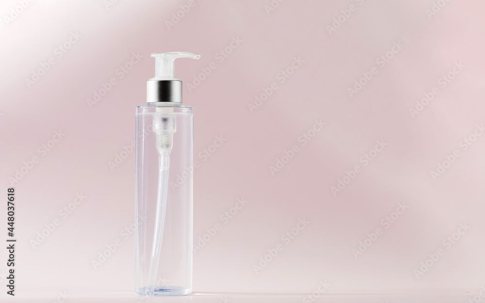 A mock-up of a cosmetic product on a pink background. Cleansing tonic for the face, micellar water. Copy space. A mock-up of a cosmetic product on a pink background. Cleansing tonic for the face, micellar water. Copy space.
