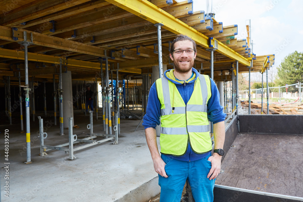 Junger Mann als Handwerker Lehrling auf Baustelle