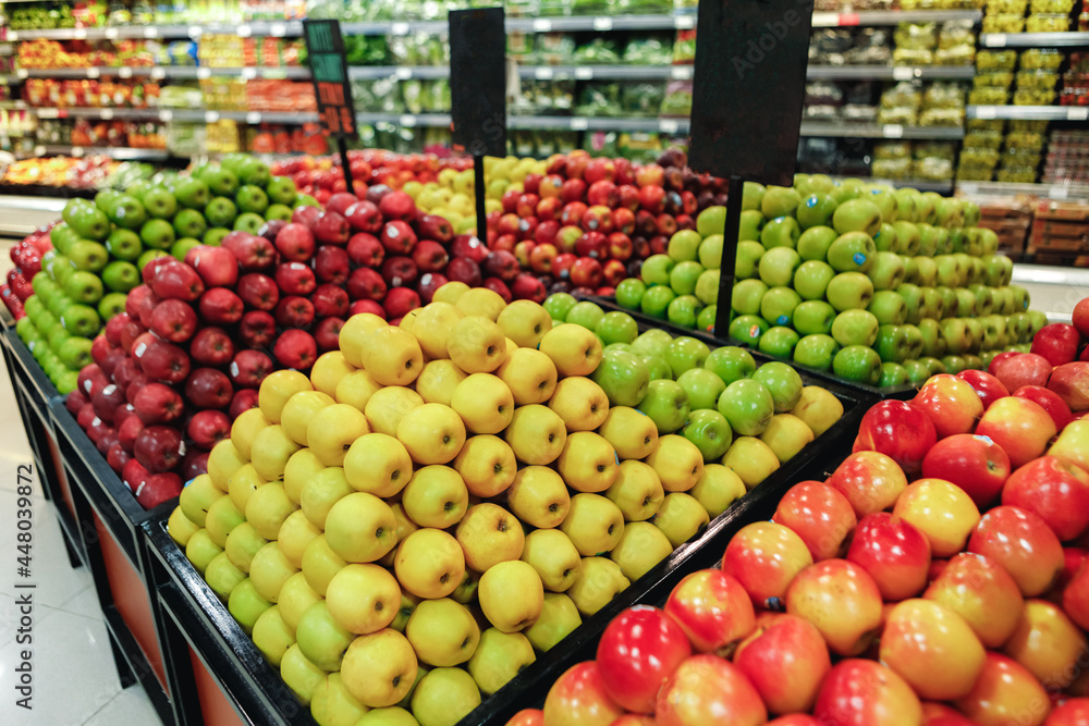 Stall with red and green fresh apples in supermarket