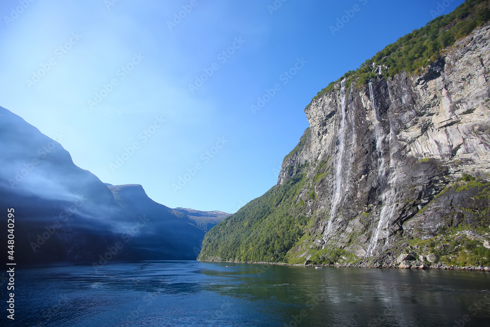 The Seven Sisters waterfall.  Beautiful fjord landscape with cliffs either side. The waterfall is located along the Geirangerfjorden in Stranda Municipality in Møre og Romsdal county, Norway.
