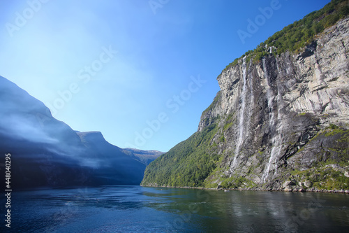 The Seven Sisters waterfall. Beautiful fjord landscape with cliffs either side. The waterfall is located along the Geirangerfjorden in Stranda Municipality in Møre og Romsdal county, Norway.