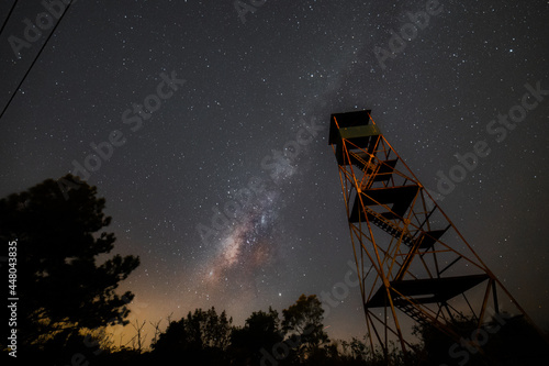 The firewatch tower under the milkyway in the night sky photo