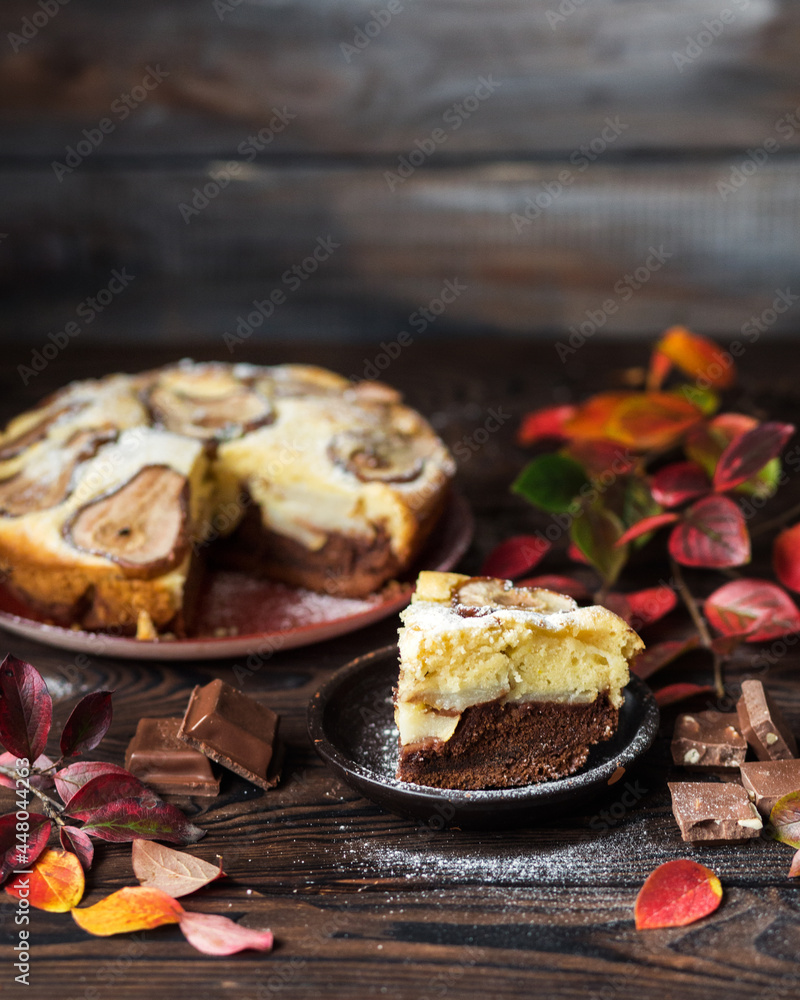 Autumn chocolate cake with cinnamon and spices. Still life of October yellow leaves on a wooden table. Homemade chocolate pastries . Autumn still life, chocolate pie with pear Autumn chocolate cake with cinnamon and spices. Still life of October yellow leaves on a wooden table. Homemade chocolate pastries . Autumn still life, chocolate pie with pear