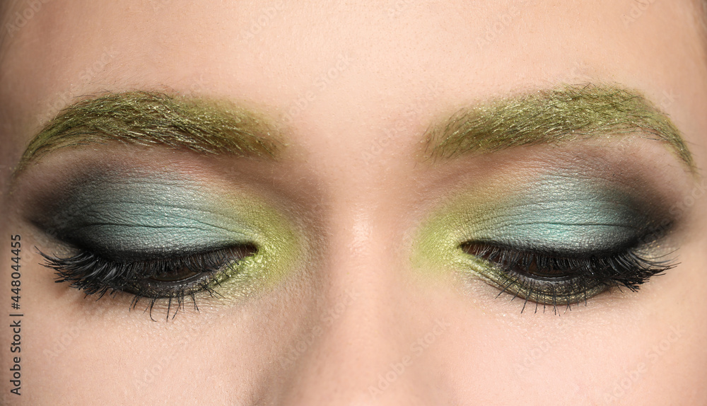 Fototapeta premium Young woman with evening makeup, closeup. Eye shadow product