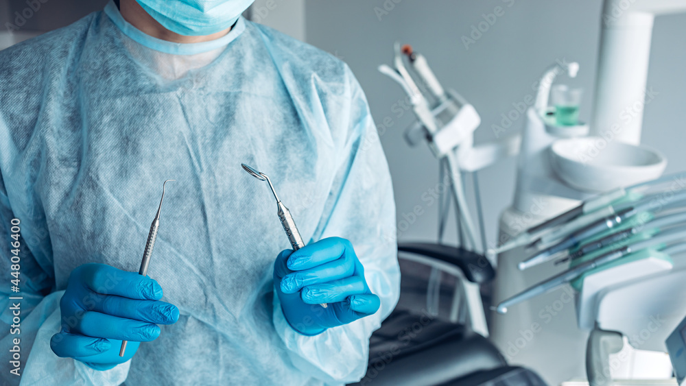 Portrait of dentist with dental tools in hands Portrait of dentist with dental tools in hands