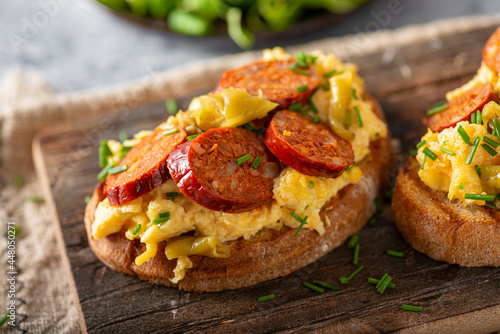 Scrambled eggs with sausage and herbs