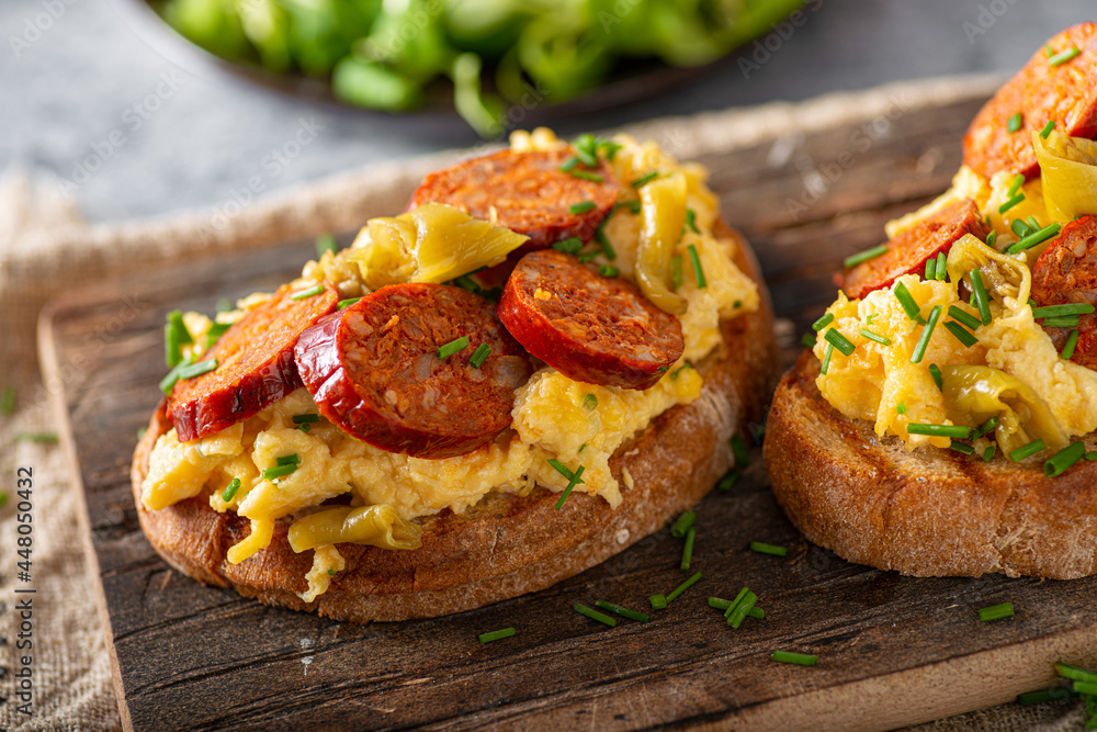 Scrambled eggs with sausage and herbs