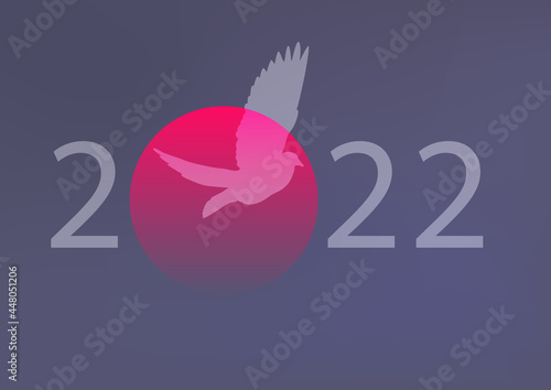 Concept de carte de vœux pour 2022, sur le thème de la paix et de la liberté avec une colombe qui s’envole devant un coucher de soleil.
