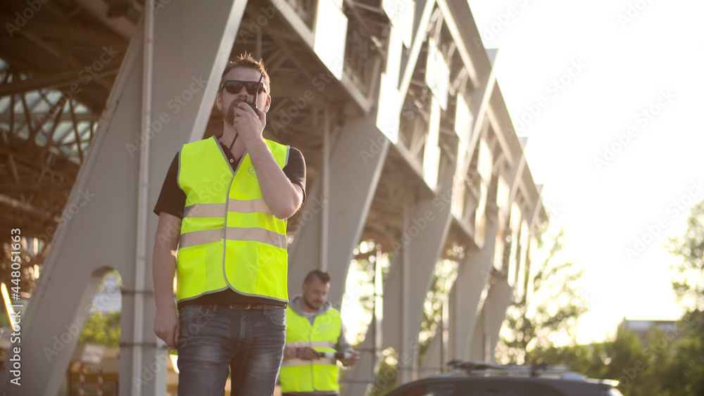 Fototapeta premium Road workers with Traffic rod using walkie talkie working at checkpoint toll roads.