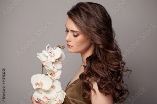 Woman with curly hair and flowers portrait