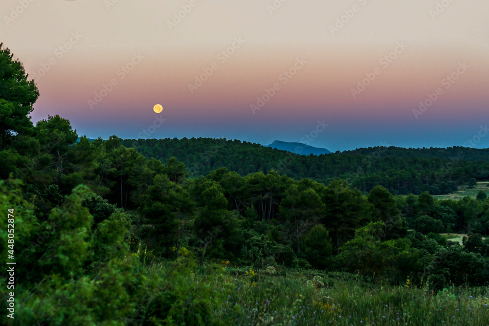 Sunrise in the Sierra de Mariola natural park with a full moon.