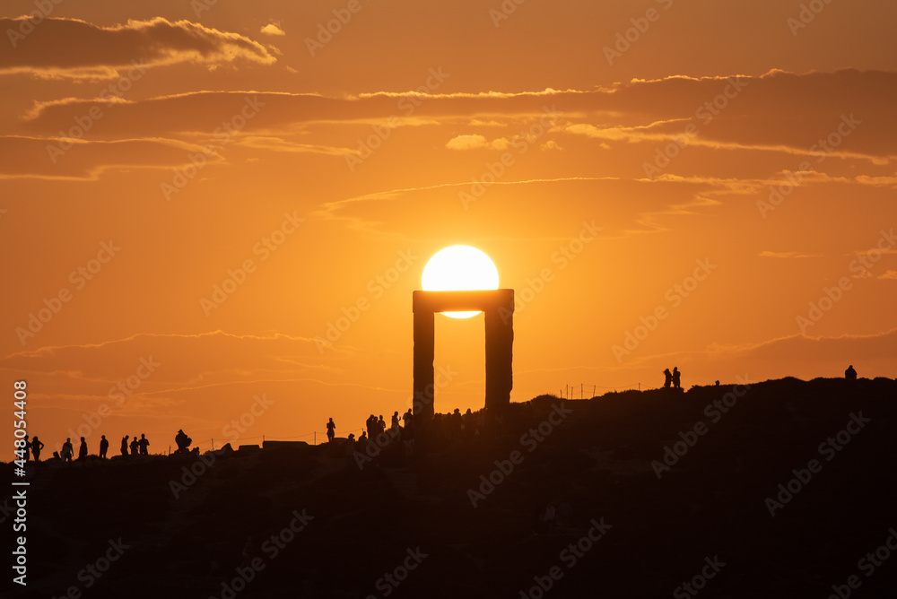 Sun framed in the Temple of Apollo at sunset, Cyclades islands, Greece