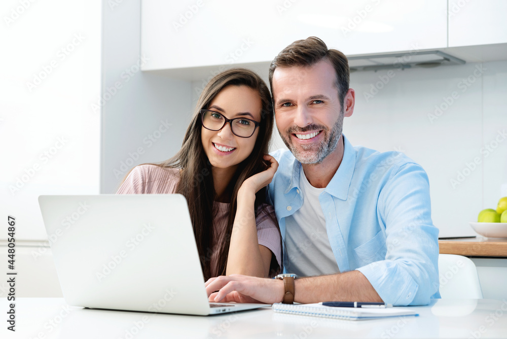 Smiling couple sitting at the computer Smiling couple sitting at the computer