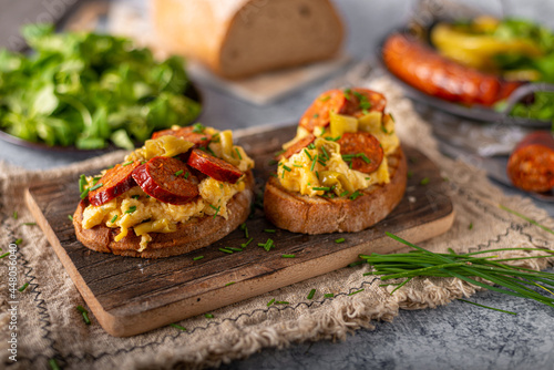 Scrambled eggs with sausage and herbs