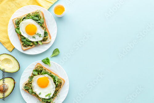 Toasts with avocado and fried eggs. Healthy breakfast