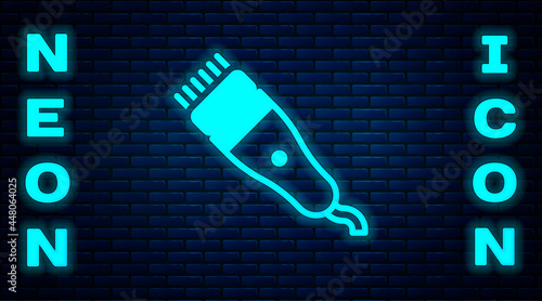 Glowing neon Electrical hair clipper or shaver icon isolated on brick wall background. Barbershop symbol. Vector