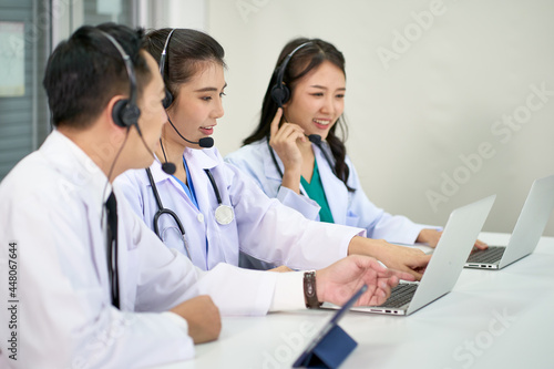 Team of asian doctors waer headset help people or patients with answers question of healthcare or medical via online service