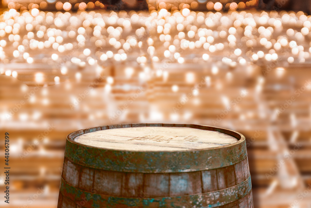 Obraz premium Golden lights on wooden background. Holiday banner of Wooden wine or beer barrel on light background