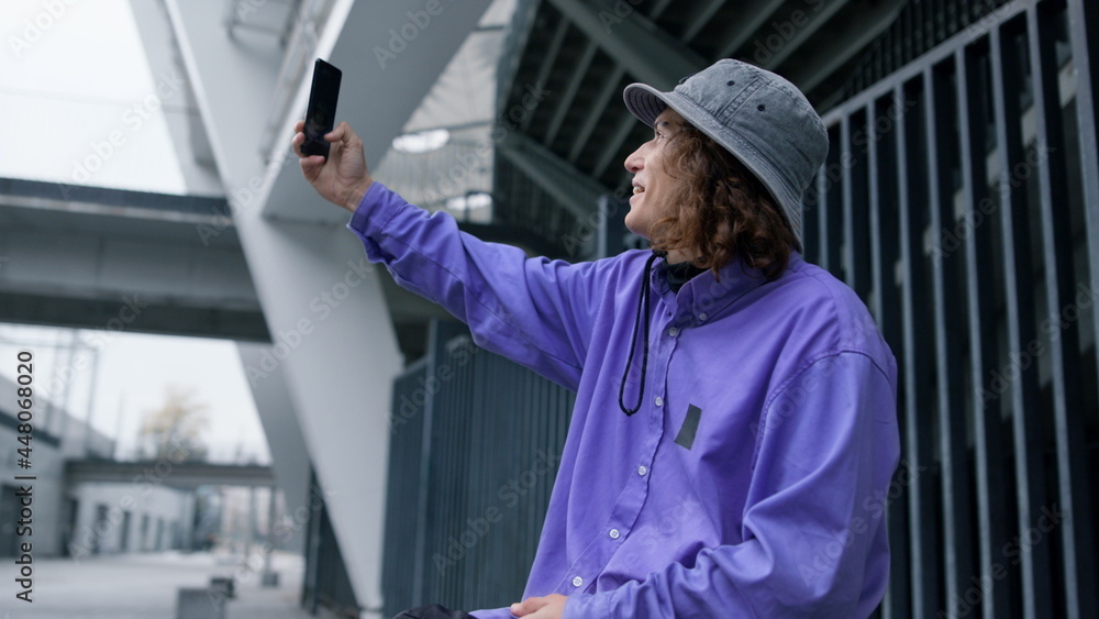 Cheerful man taking selfie on smartphone. Joyful hipster posing to cellphone. Cheerful man taking selfie on smartphone. Joyful hipster posing to cellphone.