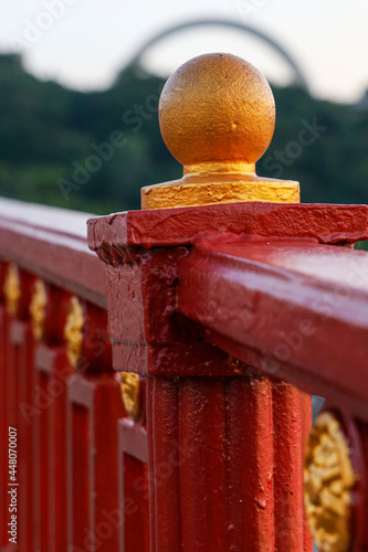 Fragment of the railing in the oriola. Part of the bridge against the background of the opposite bank. Concept for motivational text or book cover. photo