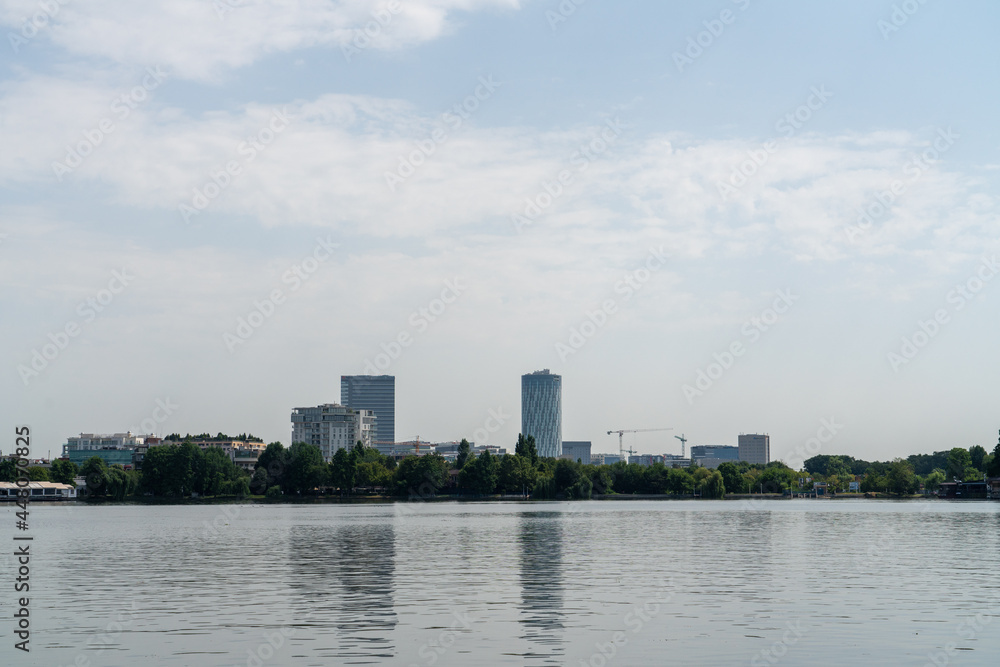 buildings in the city behind the lake buildings in the city behind the lake