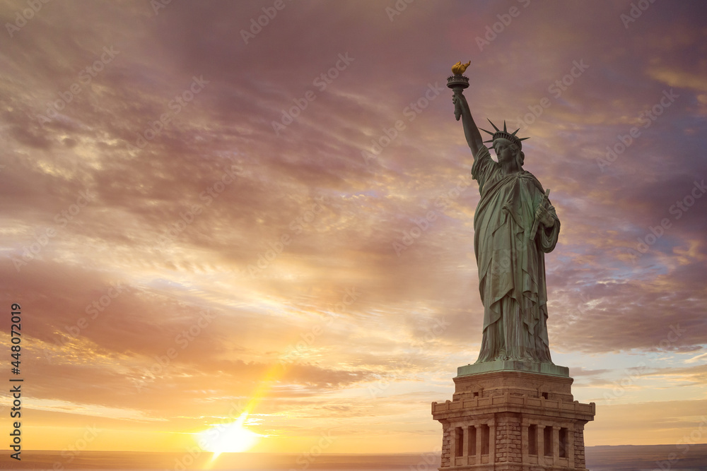 Aerial view of Statue of Liberty at sunrise in New York City