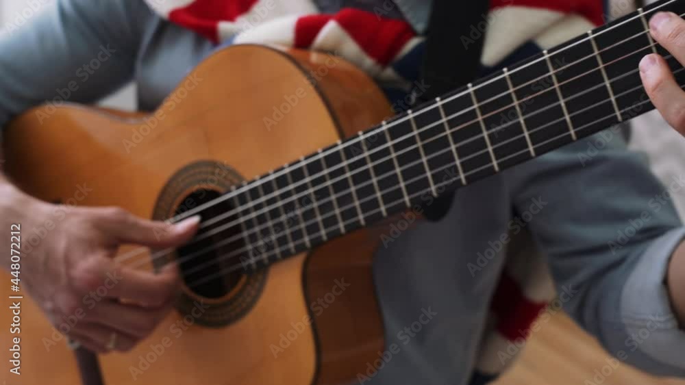 a man in a blue shirt plays the guitar with different techniques a man in a blue shirt plays the guitar with different techniques