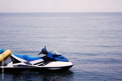 jet ski white and blue on the pier by the sea photo