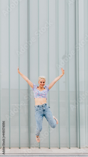 Fototapeta Naklejka Na Ścianę i Meble -  Young caucasian woman outdoor jumping celebrating success feeling free