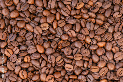 Roasted coffee beans top view, close-up. Arabica beans. Natural coffee. Coffee background.