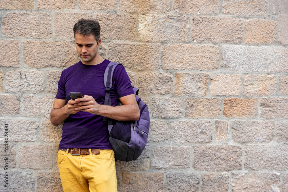Young latin man with mobile phone outdoors Young latin man with mobile phone outdoors