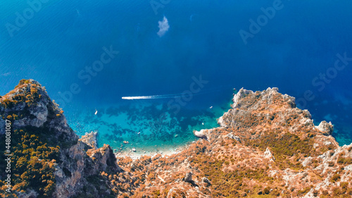 Fototapeta Naklejka Na Ścianę i Meble -  Speedboat speeding up along Capri coastline on a beautiful summer morning, Italy