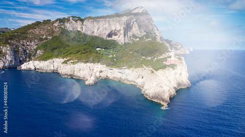 Amazing aerial view of Capri coastline along the lighthouse in summer season. photo