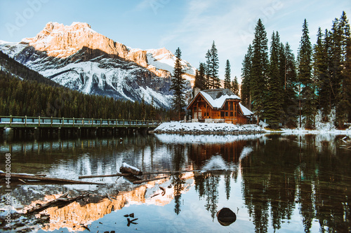 Bridge and house near snowy mountain and lake photo