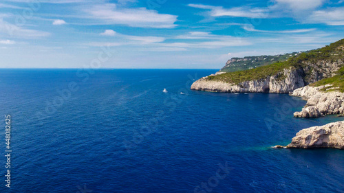 Fototapeta Naklejka Na Ścianę i Meble -  Lighthouse and Beach of Capri in summer season. View from a moving drone.