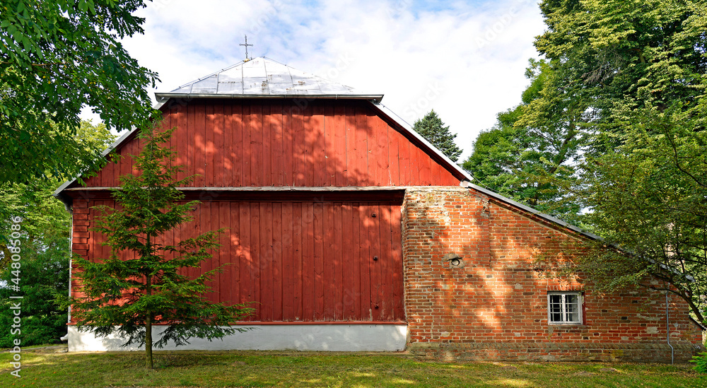 A wooden belfry and a brick chapel from the 16th century and a wooden Catholic church of Saint Zygmunt added to it in the 18th century in the town of Kraszewo in Mazovia, Poland. A wooden belfry and a brick chapel from the 16th century and a wooden Catholic church of Saint Zygmunt added to it in the 18th century in the town of Kraszewo in Mazovia, Poland.