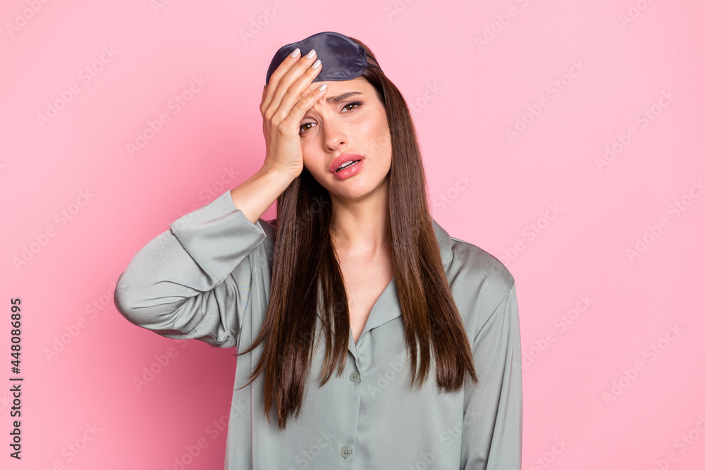 Photo of tired upset young lady sleepwear arm head isolated pastel pink color background Photo of tired upset young lady sleepwear arm head isolated pastel pink color background
