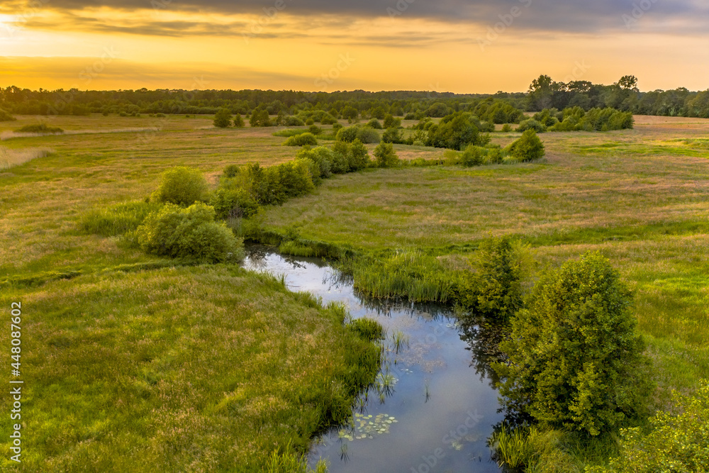 Aerial view of green grassland river valley