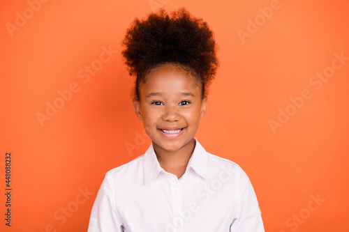 Photo of young attractive african girl happy positive smile pupil 1-september isolated over orange color background