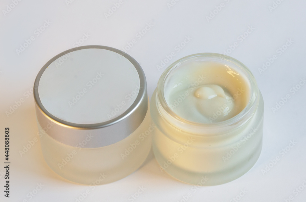 Cream in a jar on a white background Cream in a jar on a white background