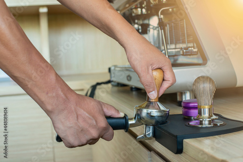 hand holding coffee powder press